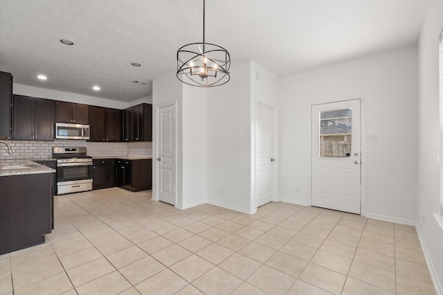 10 Garden Ridge Ct, Manvel, TX 77578 - kitchen with stainless steel appliances, a sink, backsplash, a chandelier, and dark brown cabinets