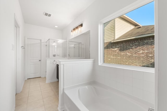 10 Garden Ridge Ct, Manvel, TX 77578 - bathroom featuring tile patterned floors, a garden tub, a shower stall, and healthy amount of natural light
