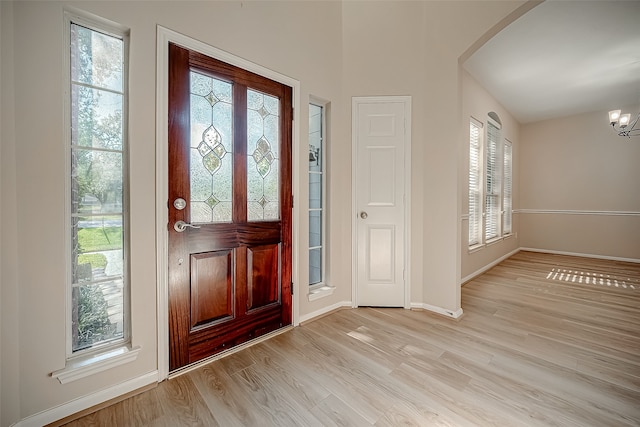 entrance foyer with a notable chandelier and light hardwood / wood-style flooring