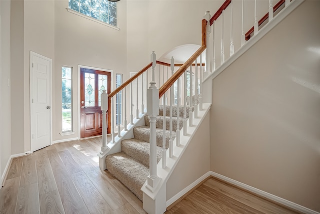 foyer featuring light hardwood / wood-style floors and a high ceiling