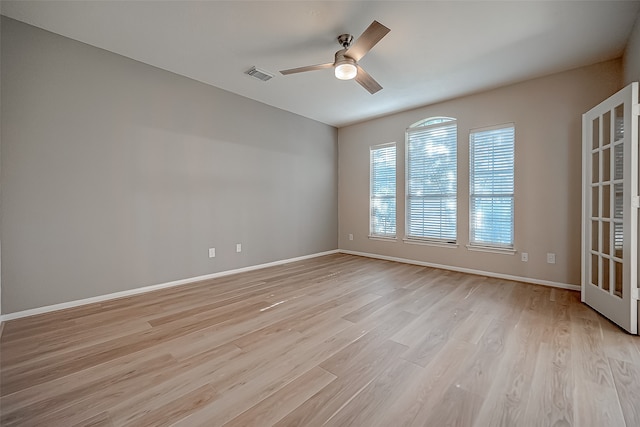 empty room featuring light wood-type flooring and ceiling fan