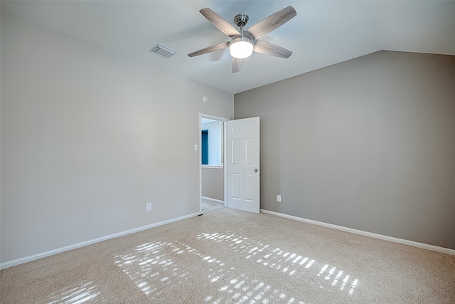 carpeted empty room featuring ceiling fan and lofted ceiling