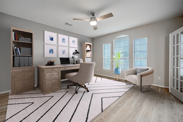 office featuring light hardwood / wood-style floors and ceiling fan