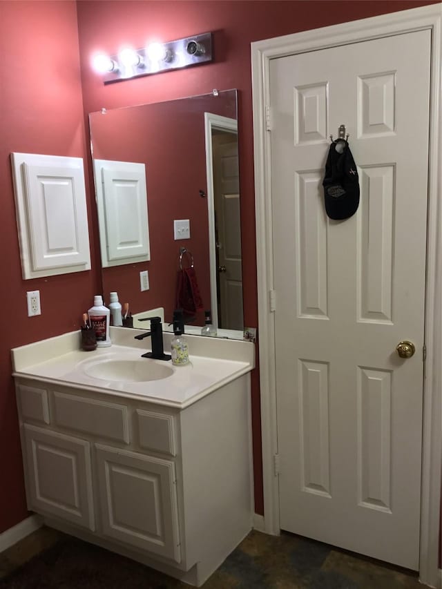 bathroom with vanity and baseboards