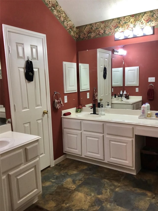 bathroom with vanity and stone finish floors