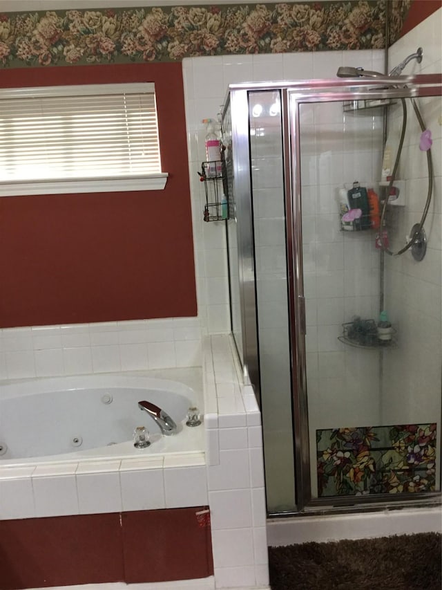 bathroom featuring a shower stall and a whirlpool tub