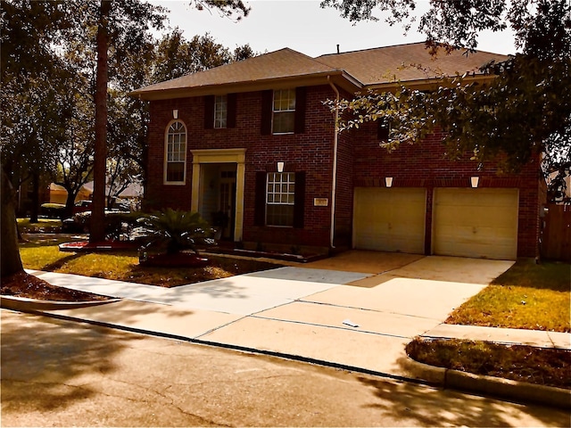 colonial house with concrete driveway, a garage, and brick siding