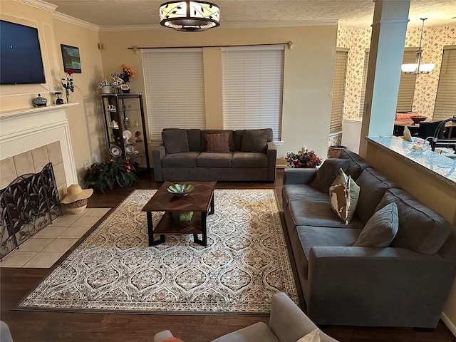 living room with crown molding, hardwood / wood-style flooring, and a fireplace