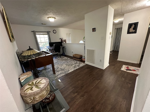 game room with a textured ceiling and dark hardwood / wood-style floors