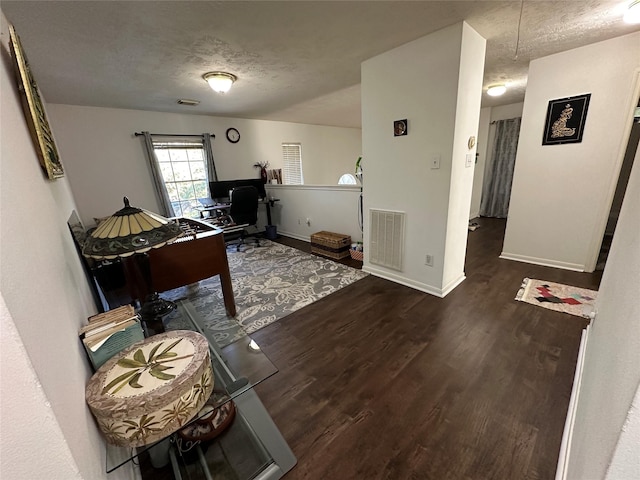 office area featuring wood finished floors, attic access, a textured ceiling, and baseboards