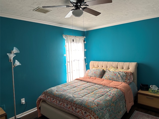 bedroom featuring ornamental molding, dark wood-type flooring, a textured ceiling, and ceiling fan