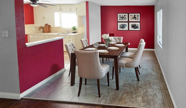 dining room featuring sink, dark hardwood / wood-style floors, and ceiling fan