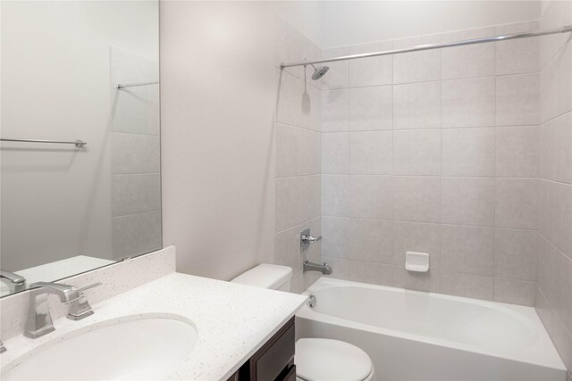 full bathroom with vanity, toilet, and tiled shower / bath