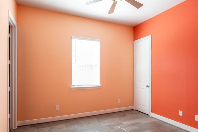 empty room with light hardwood / wood-style floors and ceiling fan