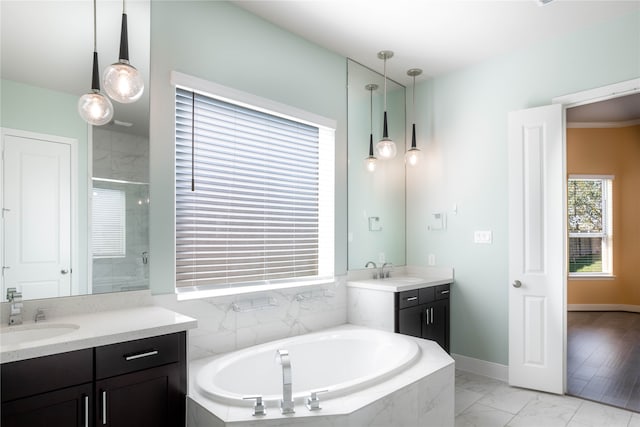 bathroom featuring vanity, hardwood / wood-style flooring, and shower with separate bathtub