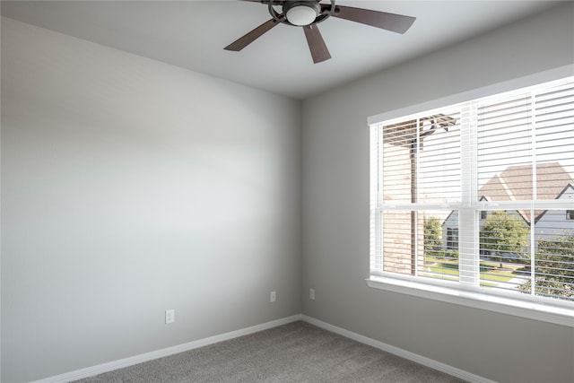 carpeted spare room with ceiling fan