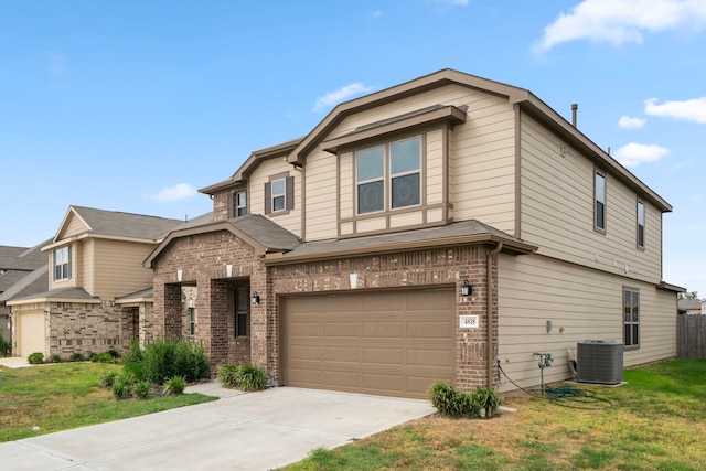 view of front facade with a front yard, a garage, and central AC