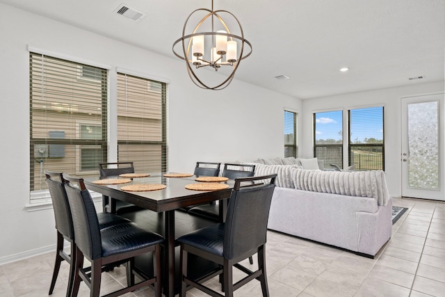 dining space with light tile patterned flooring and an inviting chandelier