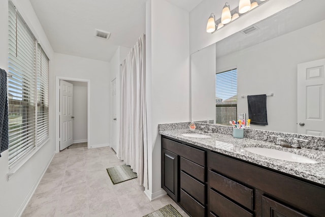 bathroom with tile patterned floors and vanity