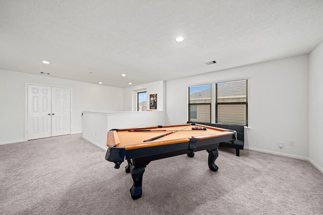 recreation room featuring light carpet, a textured ceiling, and billiards