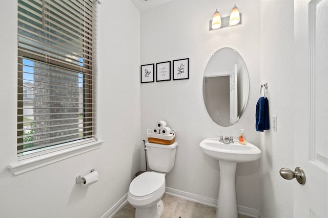 bathroom with wood-type flooring, sink, and toilet