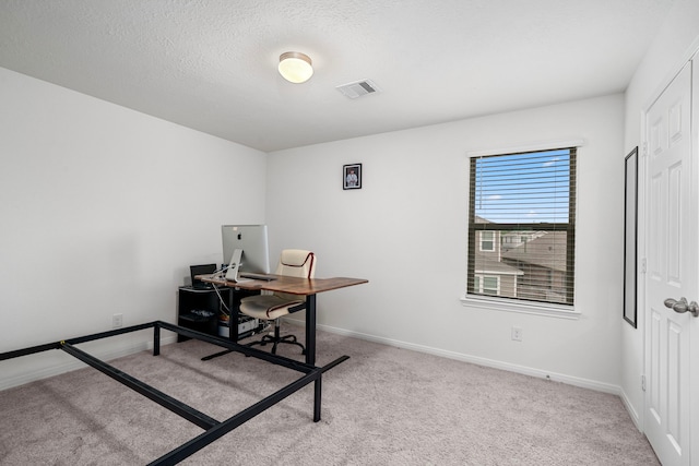 office area with light colored carpet and a textured ceiling