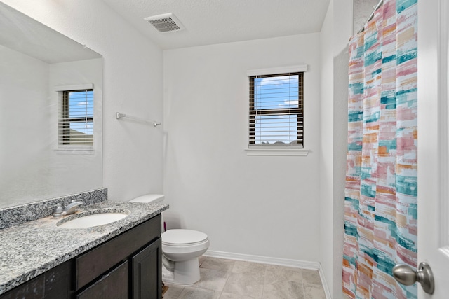 bathroom featuring vanity, a shower with curtain, tile patterned flooring, toilet, and a textured ceiling