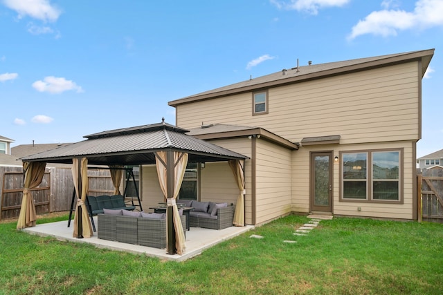 back of property with an outdoor living space, a gazebo, a lawn, and a patio area