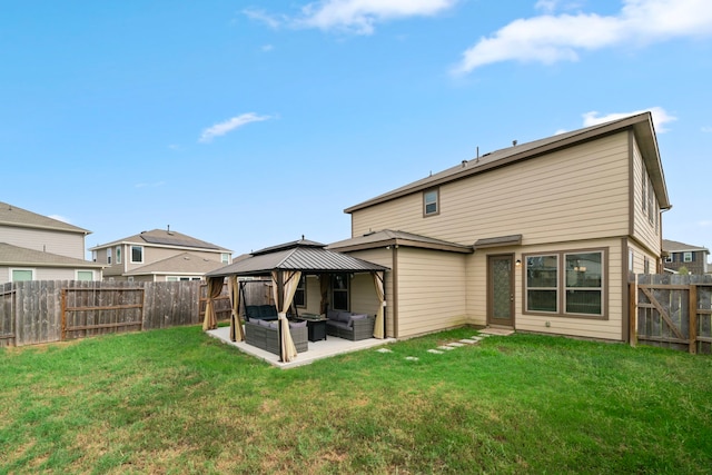 rear view of house with a gazebo, a yard, and a patio area