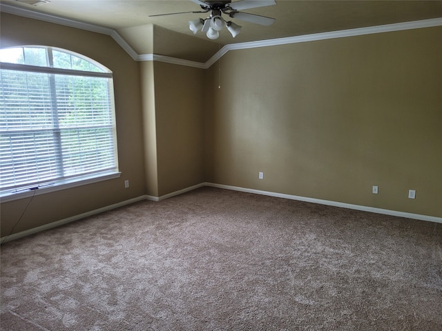 carpeted empty room with ceiling fan, crown molding, and vaulted ceiling