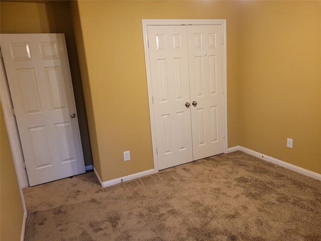 unfurnished bedroom with a closet and carpet