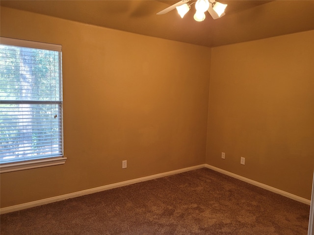 carpeted empty room featuring ceiling fan