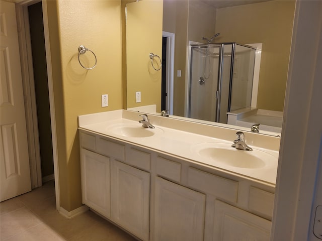 bathroom with tile patterned flooring, shower with separate bathtub, and vanity