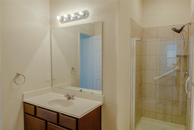 bathroom featuring vanity and tiled shower