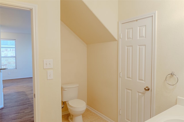 bathroom with hardwood / wood-style floors and toilet