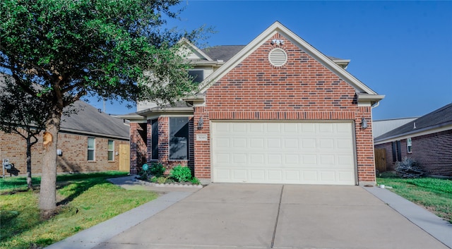 front of property with a garage and a front lawn