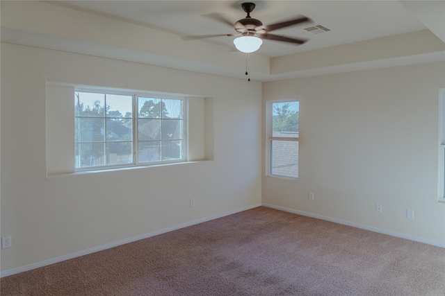 carpeted empty room featuring ceiling fan and a wealth of natural light