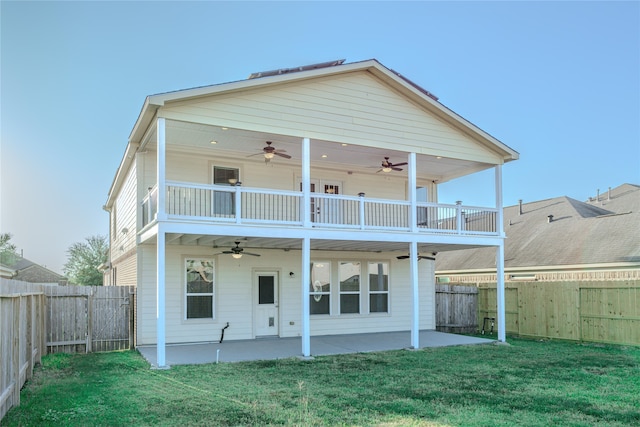 rear view of house featuring a patio area, a yard, a balcony, and ceiling fan