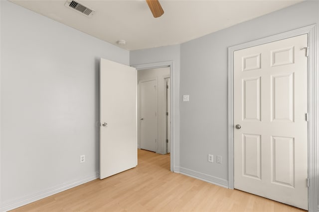 unfurnished bedroom with ceiling fan and light wood-type flooring