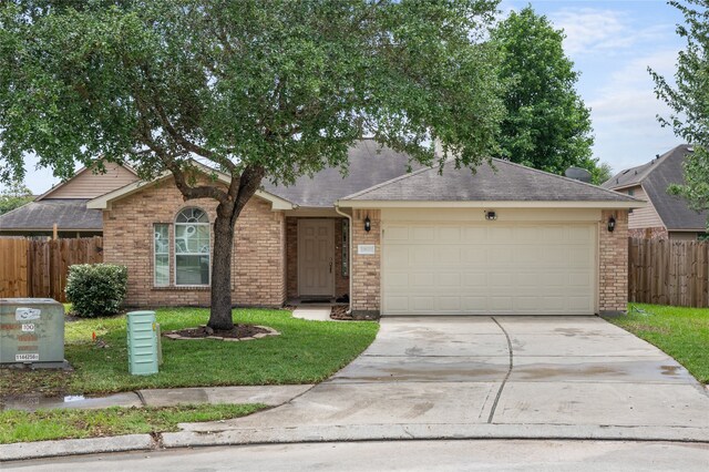 single story home featuring a garage and a front lawn