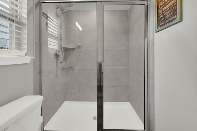 bathroom with walk in shower and toilet