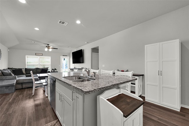 kitchen with dishwasher, a center island with sink, sink, and dark hardwood / wood-style flooring