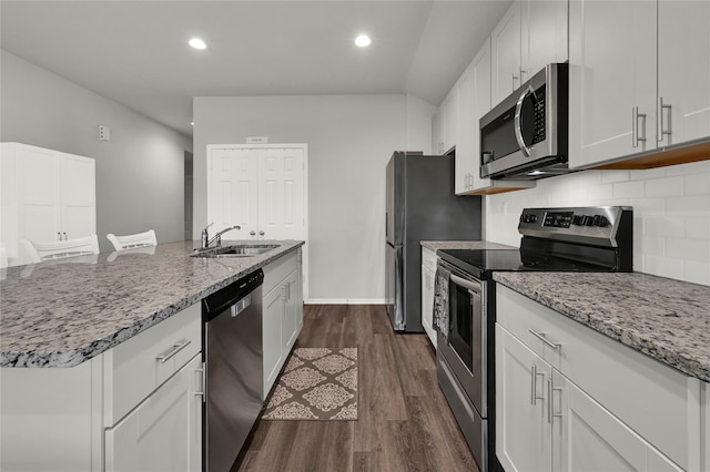 kitchen featuring dark hardwood / wood-style flooring, sink, stainless steel appliances, and white cabinets