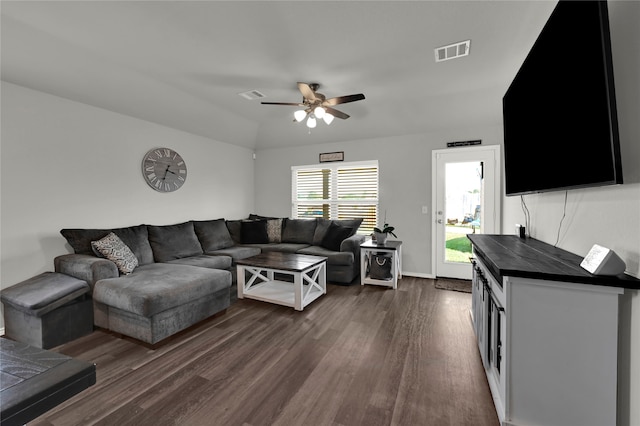 living room with ceiling fan and dark wood-type flooring