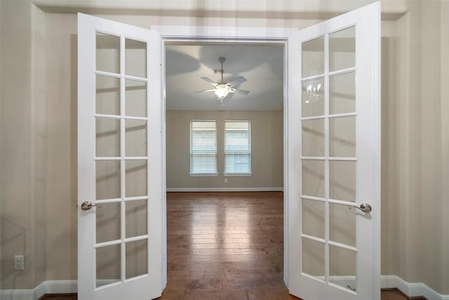 interior space with dark wood-type flooring, ceiling fan, and french doors