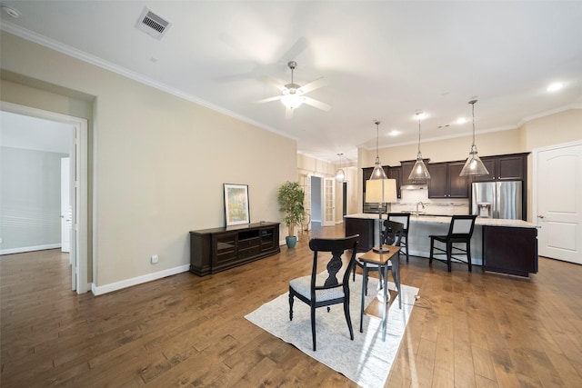 interior space with sink, ornamental molding, and dark hardwood / wood-style floors