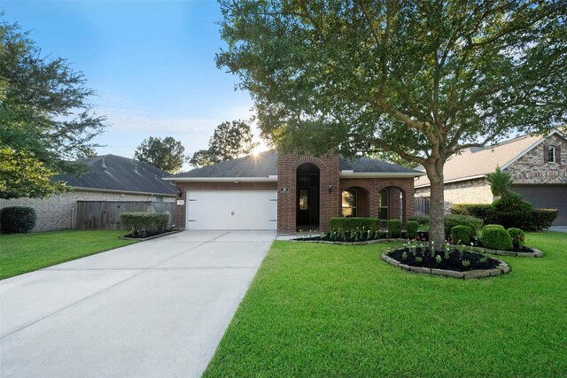 ranch-style house with a front yard and a garage