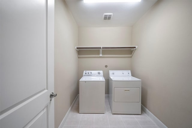 laundry area with light tile patterned flooring and independent washer and dryer