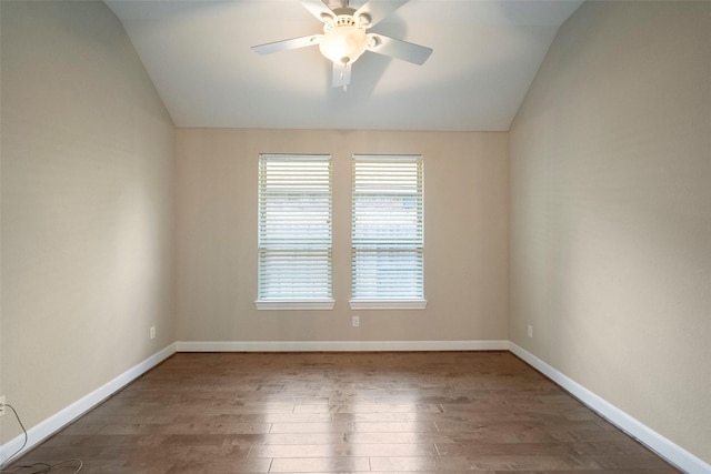 spare room featuring wood-type flooring, vaulted ceiling, and ceiling fan