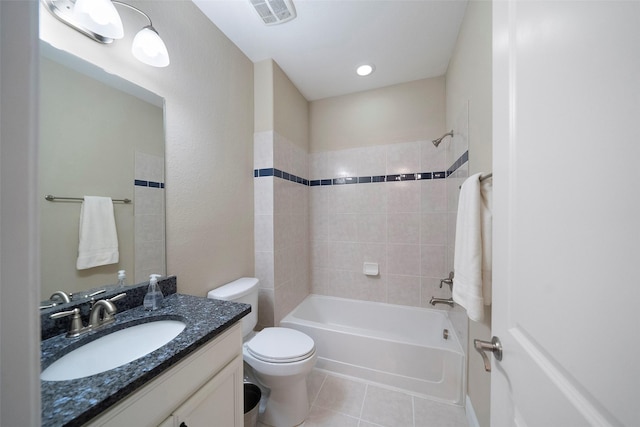 full bathroom with tiled shower / bath, vanity, toilet, and tile patterned flooring